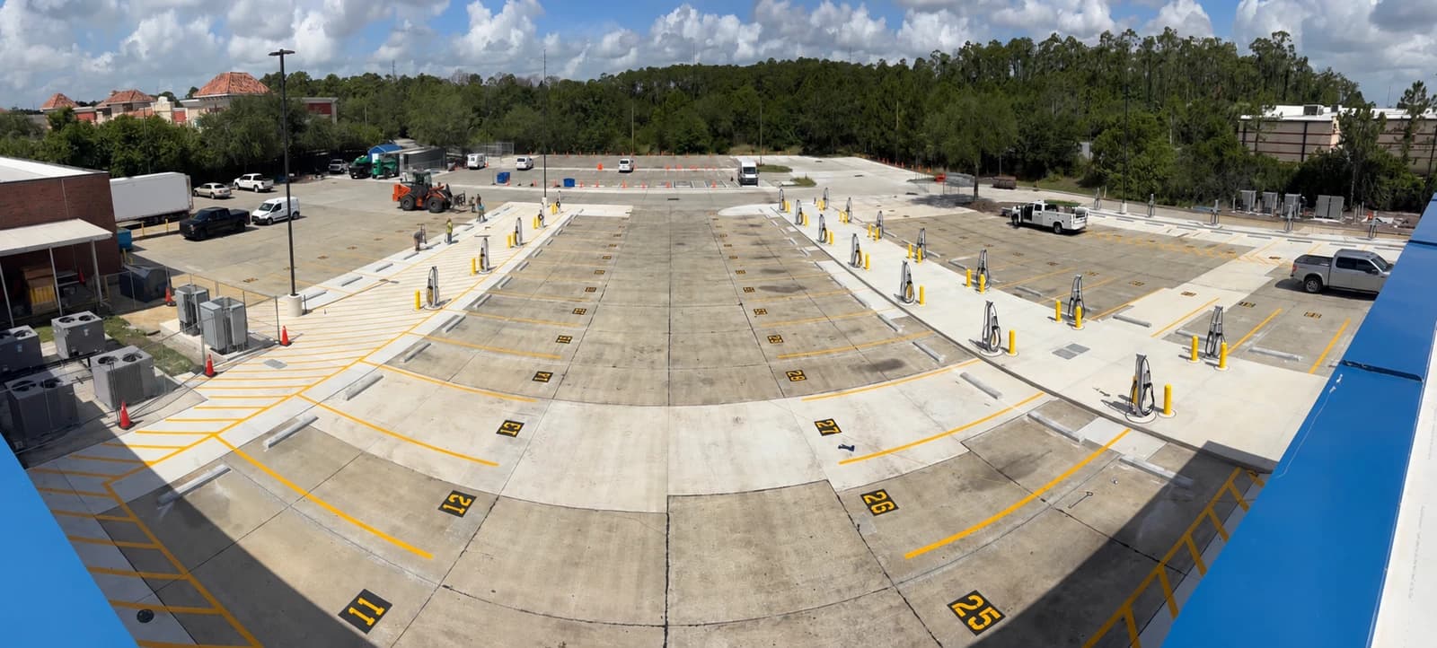 Completed concrete vehicle lot with striping and charging pedestals on an NGC General Contractors state agency site improvement project